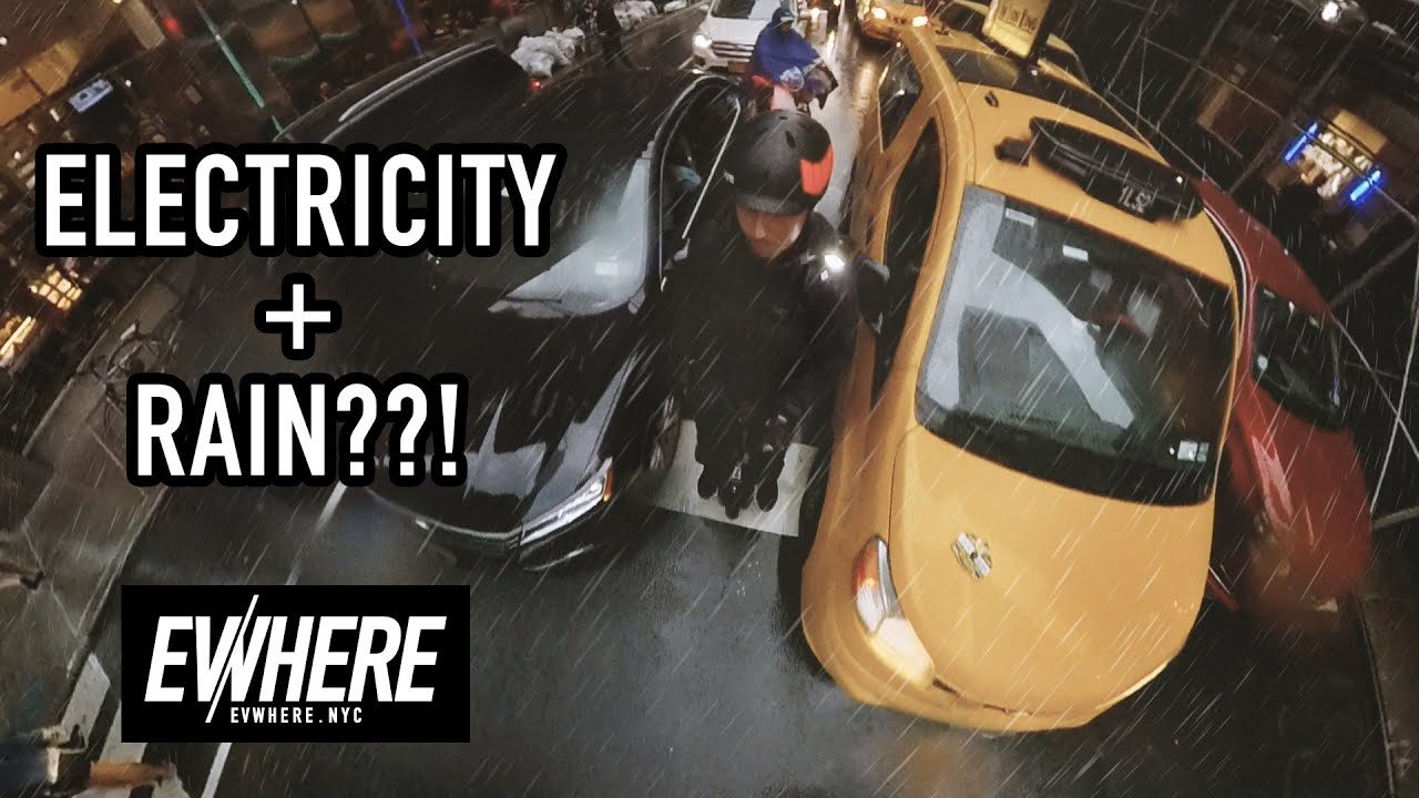 EVwhere video still: an electric unicycle in the rain beside a New York taxi